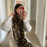Bufanda larga con estampado de leopardo en tonos marrón y negro.