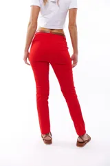 Pantalón rojo de corte recto, con bolsillos laterales y cinturón marrón.