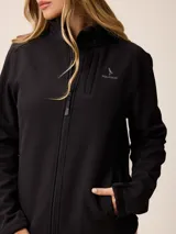 Campera softshell blanca con cierre frontal completo, cuello alto y bolsillos laterales. Presenta un bolsillo vertical con cierre en el pecho y el logo de la marca bordado.