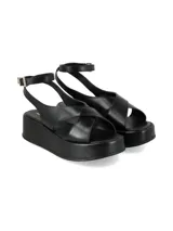 Sandalias negras de plataforma con tiras cruzadas en la parte frontal y tira ajustable al tobillo con hebilla dorada.