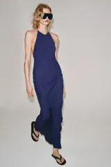Vestido largo azul marino de viscosa, con cuello halter, espalda descubierta y diseño evasé en la parte inferior.
