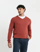 Sweater de punto con escote en V y manga larga, confeccionado en tejido acrílico con textura suave.