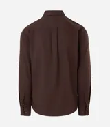 Camisa de corte slim, manga larga, con cuello camisero y cierre frontal de botones. Confeccionada en tejido plano de bambú, viscosa, poliéster y elastano.