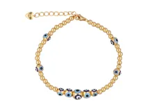 Pulsera dorada con cuentas redondas y dijes de ojo turco.