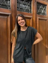 Blusa de lurex color negro con tajo en la parte delantera y mangas cortas.