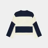 Suéter de punto con diseño de bloques horizontales en azul marino y crema, corte oversized y cuello redondo. Presenta el logo de la marca bordado en el frente en color bordó.