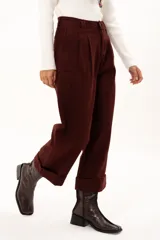 Pantalón de corte recto y tiro alto en color bordó, con diseño de pinzas en la cintura, bolsillos laterales y ruedo con dobladillo ancho.