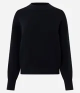 Buzo de tricot con cuello redondo y puños ajustados. Presenta un diseño de calce holgado y tejido de punto liso.