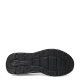 Championes deportivos Umbro modelo Glide, de diseño slip-on sin cordones, confeccionados en tejido de punto elástico color negro con suela de goma a tono.