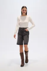 Bermuda de jean estilo boyfriend, color gris lavado, de tiro alto con bolsillos laterales y traseros, y largo a la rodilla.