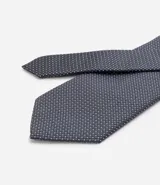 Corbata masculina de diseño clásico con textura y estampado de lunares pequeños.
