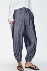Pantalón jogger de tiro bajo color azul marino con efecto melange, cintura elástica con cordón de ajuste, bolsillos delanteros y puños elásticos en los tobillos.