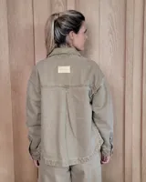 Sobrecamisa de denim con diseño de rayas verticales en tonos azules. Presenta cuello clásico, cierre frontal con botones y bolsillos delanteros de parche.