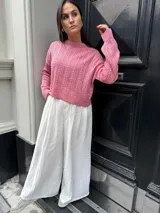 Sweater color crema tejido con diseño en ochos y cuello redondo.