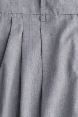 Pantalón sastrero gris de tiro alto, corte amplio y recto, con pinzas frontales y raya marcada en ambas piernas.