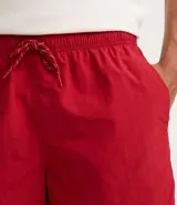 Bermuda de baño básica confeccionada en microfibra, de color blanco, con cintura elástica, cordón ajustable y bolsillos.