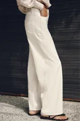Jeans Z1975 wide leg de tiro alto color crudo, con bolsillos delanteros, bolsillos de parche en la espalda, costuras laterales destacadas y cierre frontal con cremallera y botón.