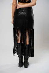 Falda midi negra de cuero sintético con flecos largos y abertura lateral.