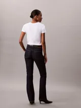 Jeans skinny bootcut de Calvin Klein con lavado clásico oscuro, tiro medio, cierre de botón y cremallera, y diseño clásico de cinco bolsillos.