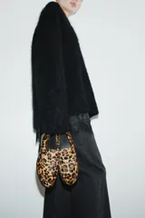 Mocasines de cuero con textura de pelo y estampado de leopardo, con diseño clásico de lengüeta decorativa y costuras frontales.