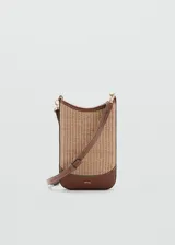 Bandolera porta celular Mango modelo Bilma, en color marrón y beige con textura trenzada, detalles en cuero sintético marrón, correa ajustable y desmontable, y cierre magnético.