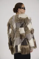 Tapado de piel sintética con diseño patchwork en tonos marrón, gris y blanco.