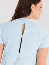 Remera deportiva de manga corta color celeste, con diseño de espalda abierta para mayor ventilación y ajuste cómodo.