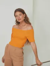 Top corto rosado con textura arrugada, escote recto y mangas cortas con volados.