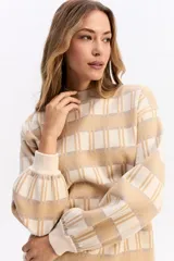 Sweater de punto con diseño de cuadros en tonos beige y crema, de silueta relajada, cuello redondo y mangas largas con puños elásticos.