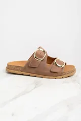 Sandalias marrones de cuero con dos tiras anchas ajustables con hebillas doradas. La plantilla es de corcho y la suela es de goma.