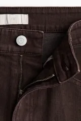 Jean de corte bootcut y tiro alto en color marrón oscuro, con diseño de cinco bolsillos y raya marcada en el frente y la espalda.