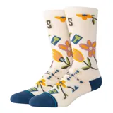 Medias Stance Harvest Crew de color crema con puño, talón y puntera en azul marino. Presentan un estampado con flores, letras y símbolos geométricos de colores.