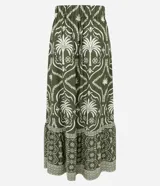 Pollera larga (midi/maxi) de tejido piqué, color verde oscuro con estampado en blanco/beige de motivos tropicales y palmeras. Presenta un diseño con fruncido en la parte inferior.