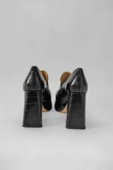 Mocasines color beige con estampado de piel de cocodrilo, plataforma y tacón cuadrado.