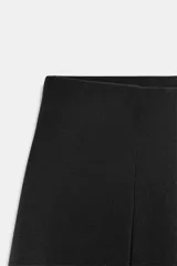 Bermuda de tiro medio color negro, con cintura elástica y detalle de pliegues delanteros.