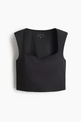 Top deportivo negro de corte cropped, con escote corazón, soutien incorporado y tejido funcional SculptMove que realza el contorno corporal.