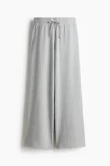 Pantalón de punto waffle con cintura elástica, cordón ajustable y piernas amplias de corte recto.