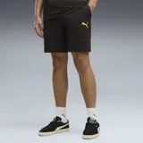 Shorts Puma color negro con detalles en amarillo, con el logo de la marca impreso en una pierna y bolsillos laterales.