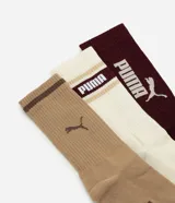 Pack de tres pares de medias de caña alta Puma de algodón. Incluye un par celeste, un par blanco con detalles verdes y un par verde oscuro, con logo de la marca estampado.
