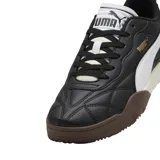 Championes Puma modelo Tifosi, de diseño urbano con capellada en color negro, detalle de franja lateral blanca y suela de goma en tonos marrón y crema.