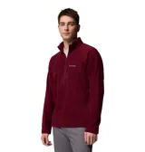 Buzo polar de hombre con cierre frontal parcial y cuello alto. Presenta un bolsillo vertical con cierre en el pecho y el logo de la marca bordado. Confeccionado en tejido polar suave, ideal para actividades al aire libre.
