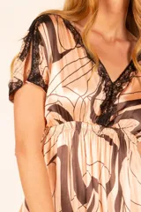 Vestido midi color salmón con estampado abstracto en marrón, escote en V con detalle de encaje negro y mangas cortas.