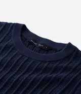 Remera masculina de algodón con textura acanalada y efecto punto. Presenta un diseño de corte regular, cuello redondo y manga corta.
