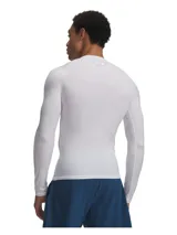 Remera de compresión de manga larga Under Armour, modelo HeatGear Elite, en color blanco. Presenta un diseño ergonómico con costuras estratégicas para mayor durabilidad y libertad de movimiento, confeccionada en tejido técnico de secado rápido con tecnología de control de olores.
