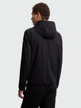 Chaqueta híbrida Moncler Grenoble negra con cuerpo acolchado y mangas de tejido liso. Presenta capucha fija, cierre frontal y logo de Moncler Grenoble en el pecho izquierdo.