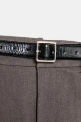 Pantalón tobillero de tiro medio con pinzas delanteras, bolsillos frontales y falsos bolsillos de vivo en la parte trasera. Presenta un bajo acabado en vuelta y se ajusta con un cinturón incluido, cierre frontal con cremallera, botón interior y gancho.