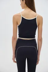 Top corto deportivo o para el agua, con estampado a rayas verticales azules y verdes, con ribete rojo.