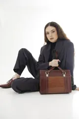 Cartera tipo shopper de cuero genuino marrón con panel central de textura símil cocodrilo y herrajes metálicos plateados.