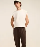 Pantalón de corte recto confeccionado en tejido de algodón y poliéster, con cintura elástica ajustable mediante lazo y bolsillos laterales.