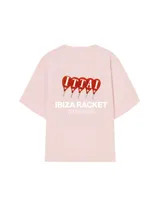 Remera color crema de corte oversize con estampado en la espalda que incluye cuatro paletas de pádel rojas con la palabra 'ITTAI' perforada, y texto debajo que dice 'IBIZA RACKET ITTAI STARS'.